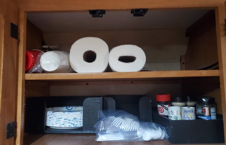 Cups, plates, paper towels, silverware, and seasoning for cooking.