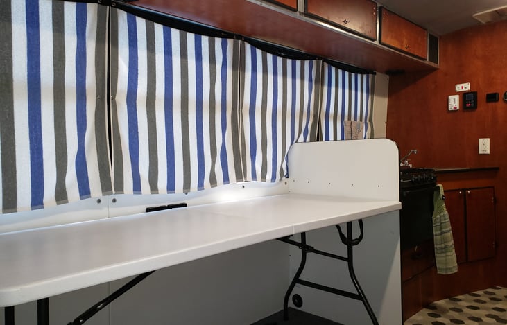 Folding table stows and can be used inside or outside