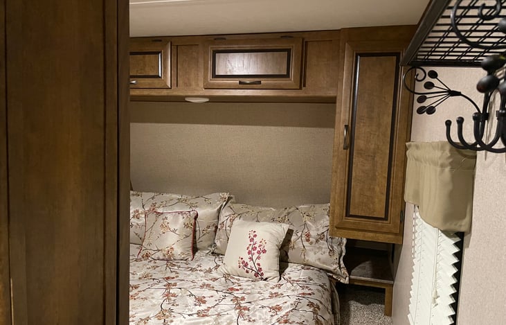 Master bedroom with queen bed, TV, cabinets and wardrobe closets.