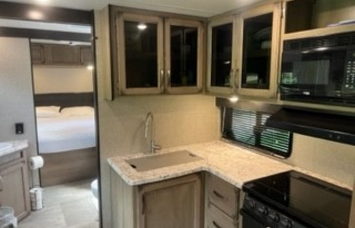 Stove, Oven, Microwave. View from Den into Master Bath and Master Bedroom