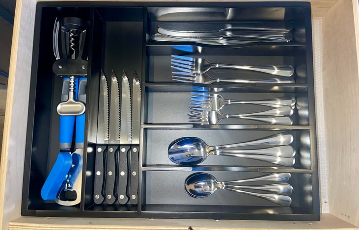Kitchen utensils include: 
4x small spoons
4x dinner spoons
4x small forks
4x dinner forks
4x dinner knifes
4x steak knifes
1 Can opener 
1 Wine opener