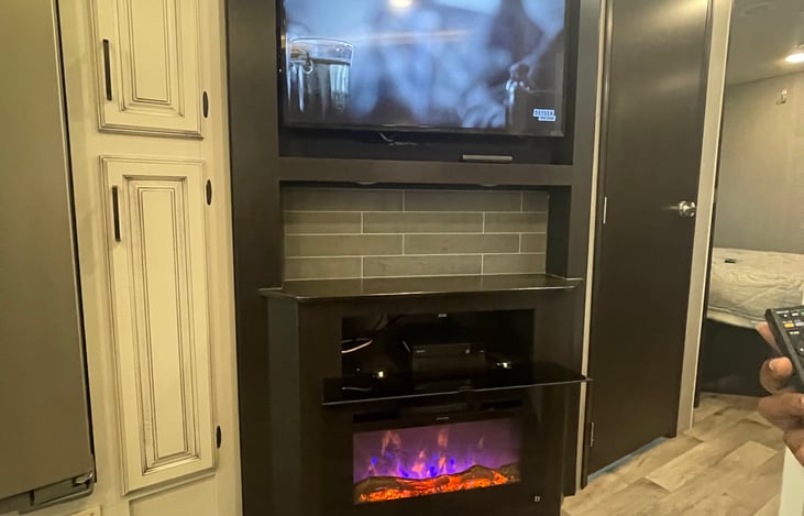 Television with sound bar and DVD and fireplace. The sound bar is top notch and provides a theater sound experience.