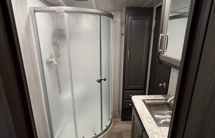 Full bathroom with shower, sink and toilet