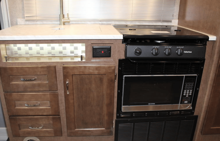 Microwave is conveniently located below the cook top.