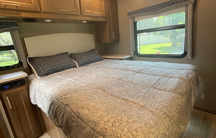 Spacious master suite with queen size bed, TV, Bluetooth stereo, and entry into the bathroom