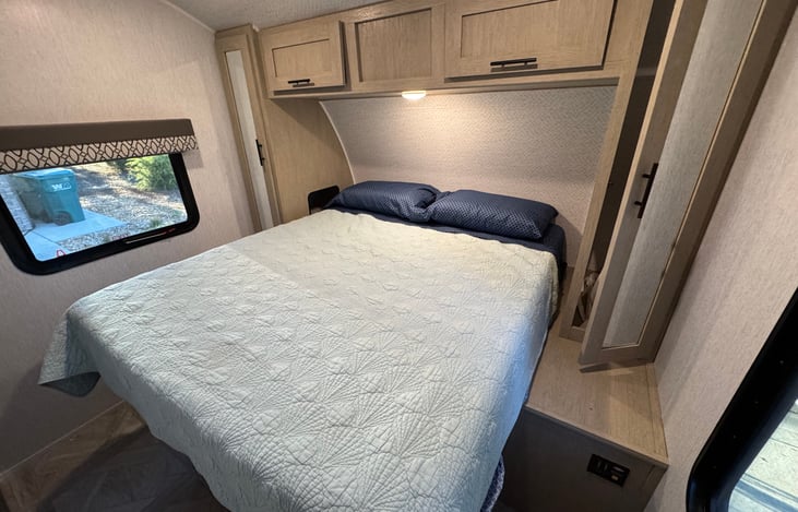 The main bedroom has an RV King, a large closet & two side closets. Side closets have outlet & USB access & a toddler bed rail if needed.