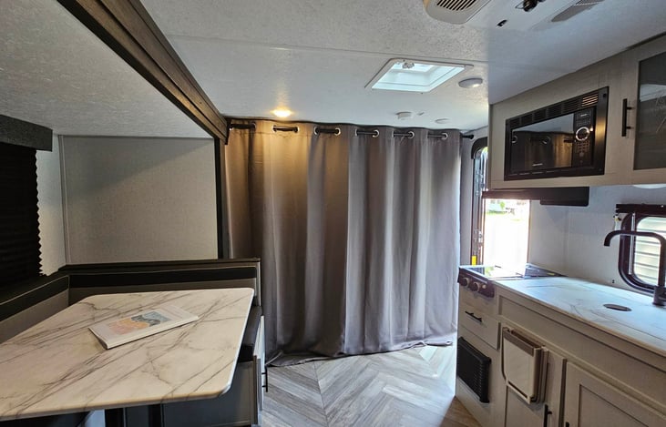 Curtain closed (couch/master bed behind). View from the bathroom.