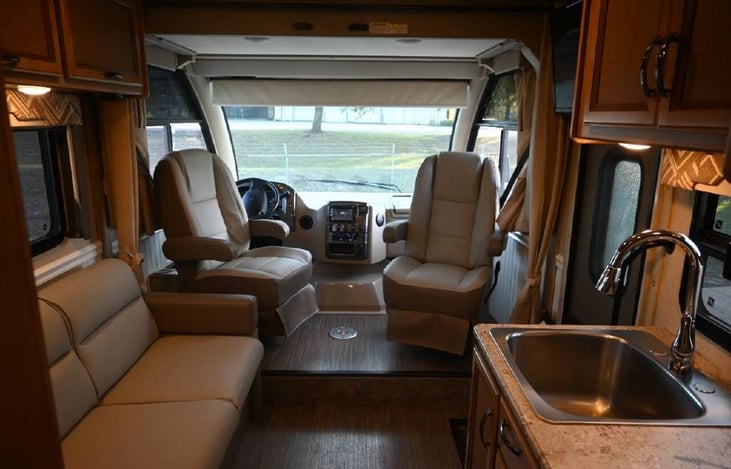 Custom upholstered captain chairs swivel for additional seating...small removable table (not shown) adds a nice convenience.