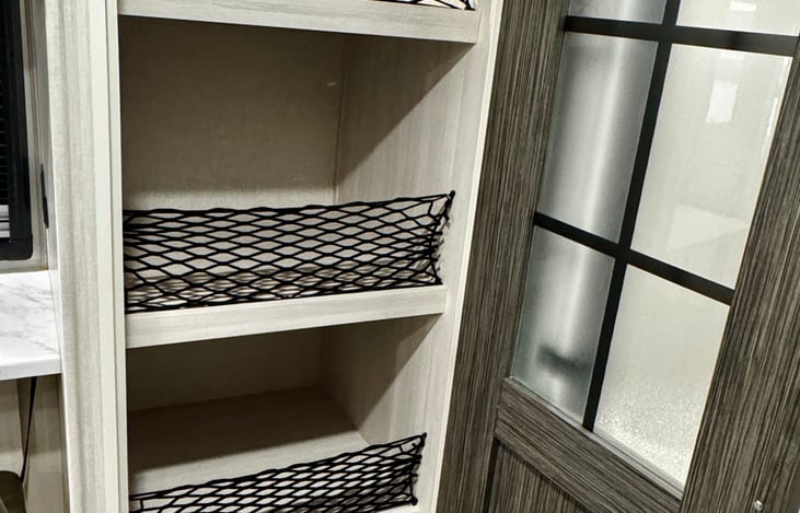The pantry delivers incredible storage space, perfect for organizing snacks, dry goods, and kitchen essentials so everything stays neat, tidy, and easy to access on the road.