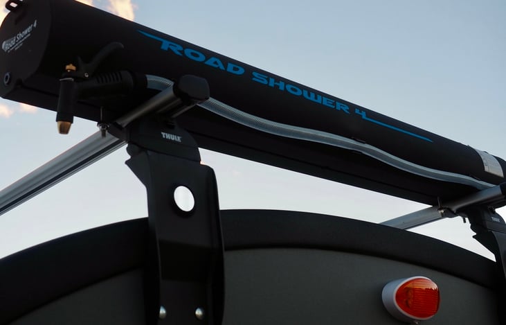 Solar heated and pressurized road shower