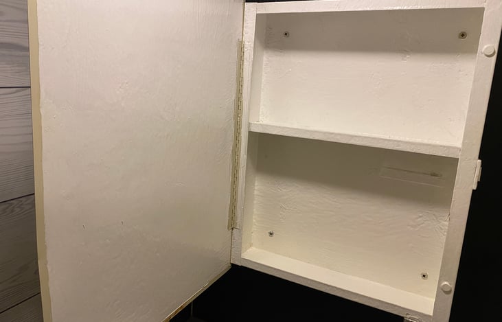 A full-sized medicine cabinet in the bathroom has been carefully restored and placed above the sink in the bathroom.