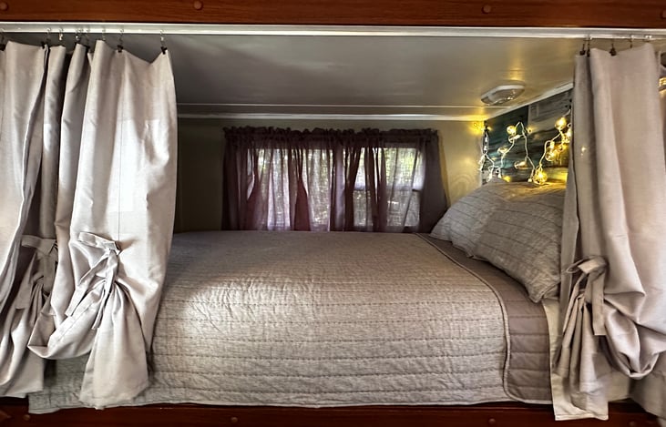 F/Q master bed. Brand new mattress 2026 and all pillows and bedding… new curtains on windows and privacy curtains for when sleeping. USB outlet / plug at head of bed.