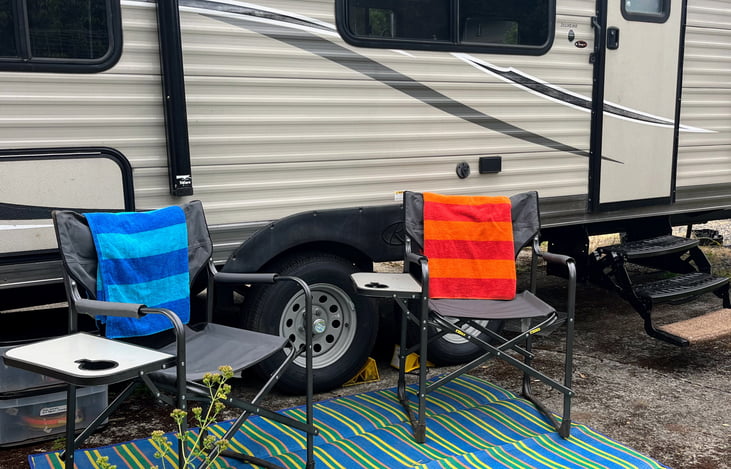 Camping chairs and entry mat/picnic blanket (awning extends too)