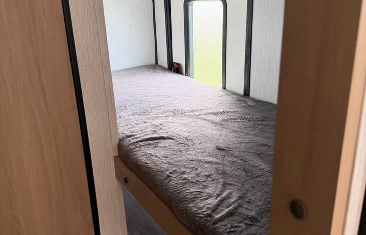 Cozy rear twin bunk beds—the perfect private nook for the kids, extra guests, or storing your bulky adventure gear securely while on the move.