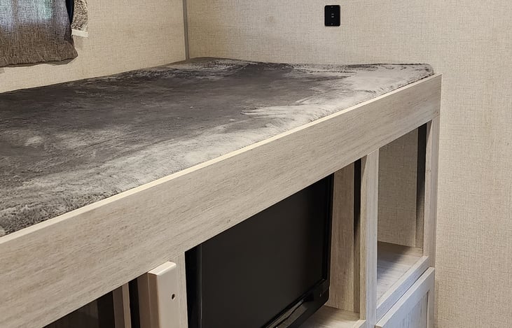 Bunk bed above the entertainment center area