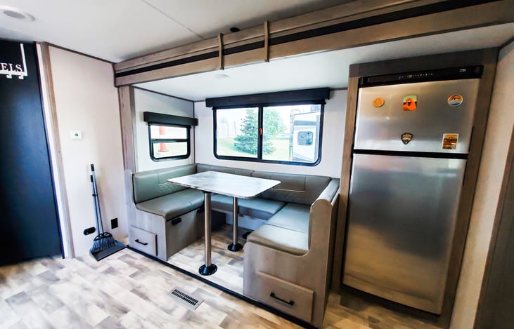 Slide out with a U shape dinette and 12v refrigerator.