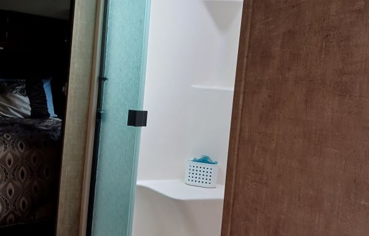 Very spacious walk-in shower with glass doors.