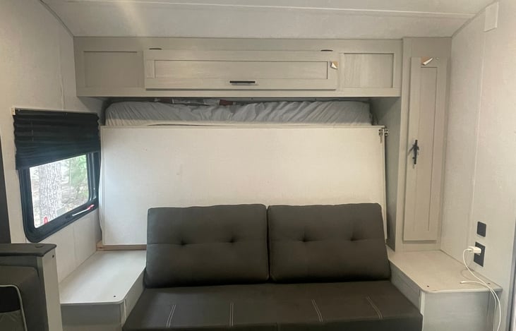 Comfortable sofa to wind down, closet to the right for camping supplies and storage above (that's where we keep the board games)