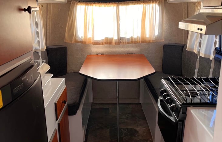 Rear dining table converts to bed