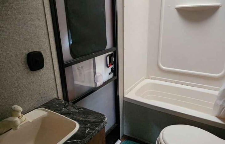 Flushable toilet, shower with detachable head for washing. There’s also an outside shower.