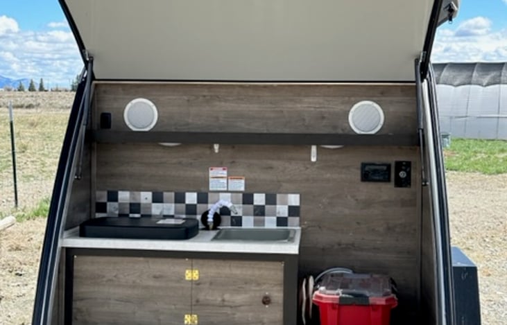 Kitchen with 12V and 120V (when plugged in) with the rear gate as shade