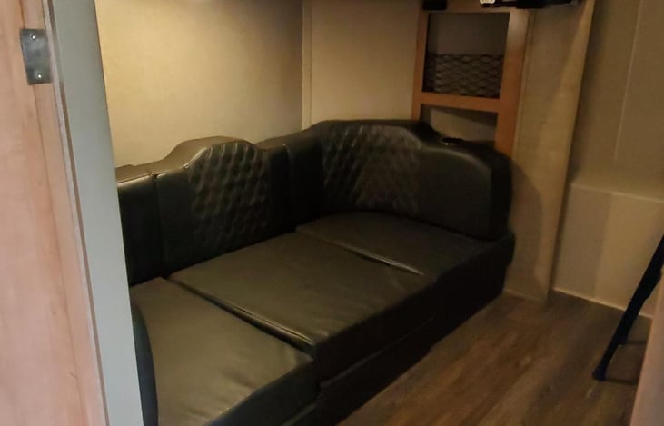 Couch in bunkroom folds out to fit 2 people.