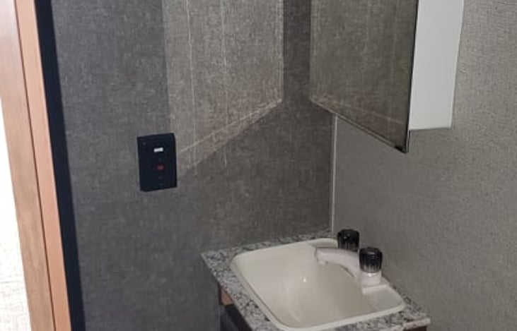 Bathroom--- toilet, sink, shower, and bathtub.