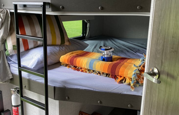 Double size bunkbeds with large open windows for viewing and personal airflow, individual USB ports, individual lighting, and privacy curtains.