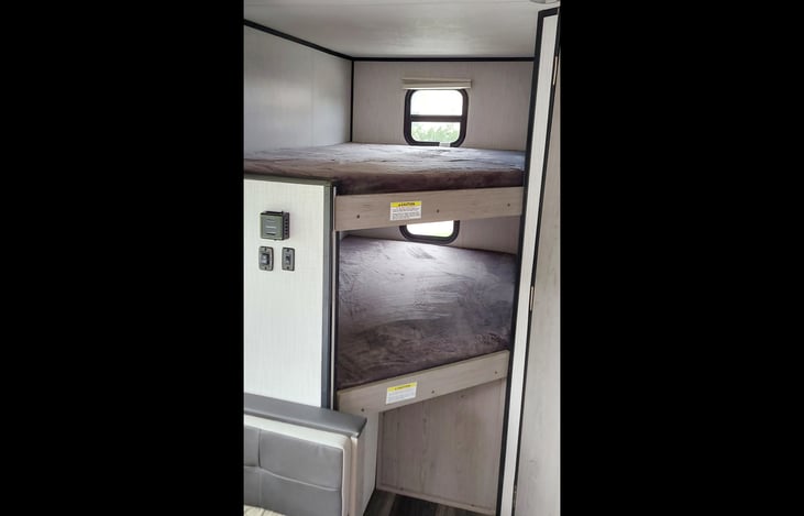2 Full size bunks (200 lb. capacity each), small storage niche (for phones etc.), 2-plug electrical outlet.