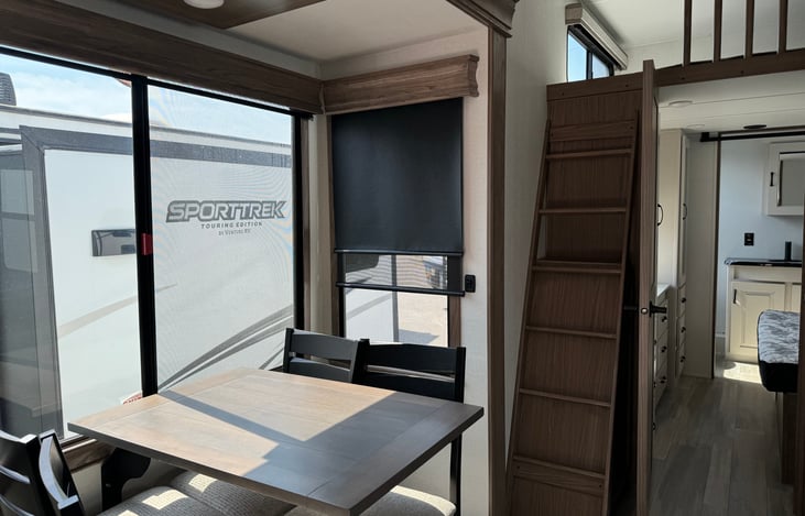 Dining area with ladder up to lift area