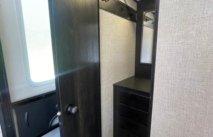Bedroom, step in closet with private door to exit camper. Closet contains vanity area with plugs for easy dressing.