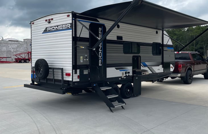 Front door with extended awning, outdoor fridge and griddle in center on outside. Back carries up to 200 lbs in rack