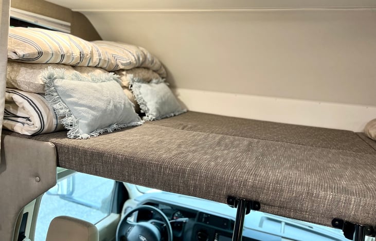 Queen bunk bed over cab with full bedding set