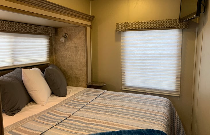 Walk-around queen bed with TV