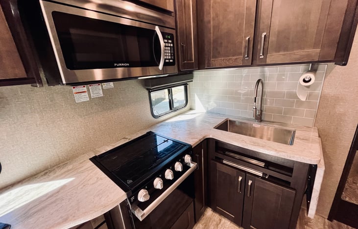 Full kitchen with plenty of storage. Please note that microwave requires shore power or a generator.