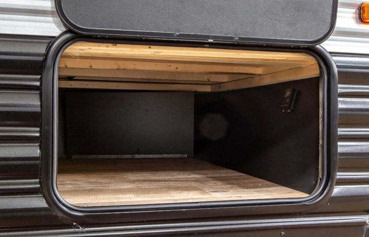 Lots of storage under the queen bed that can be accessed through this external locking door or from inside by lifting the bed.