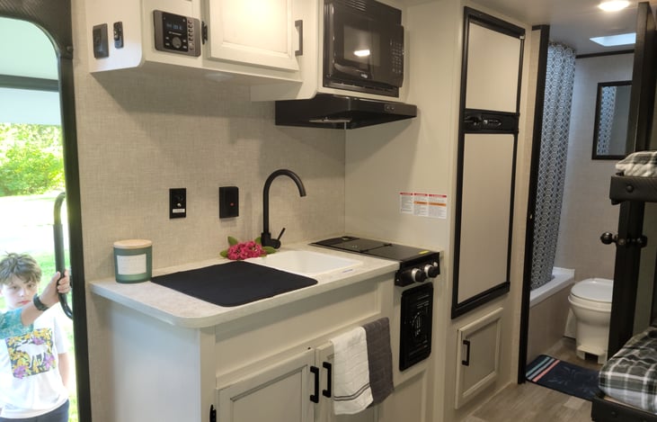 Sink, stove, fridge & microwave.