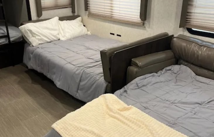 Dinette and sofa make into beds to fit whole family.