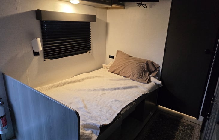 Dining table converted to a single bed. Bedding provided upon request.