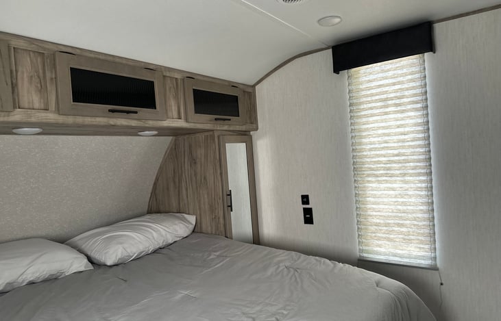 Huge bedroom with queen sized bed, two closets and overhead storage.