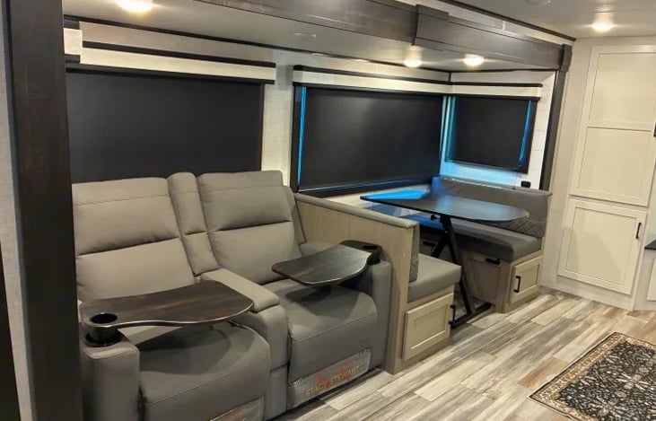 Family-Sized Slid out expands the main living area significantly, housing a deep booth dinette and a plush trifold sofa where everyone can unwind together.