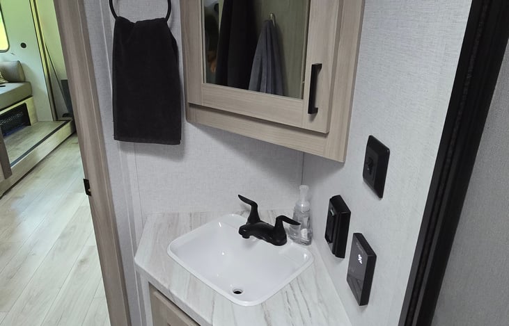 Hand soap provided, first aid kit in the cabinet