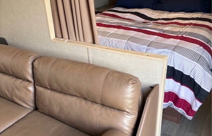 Queen size bed and leather futon sofa.