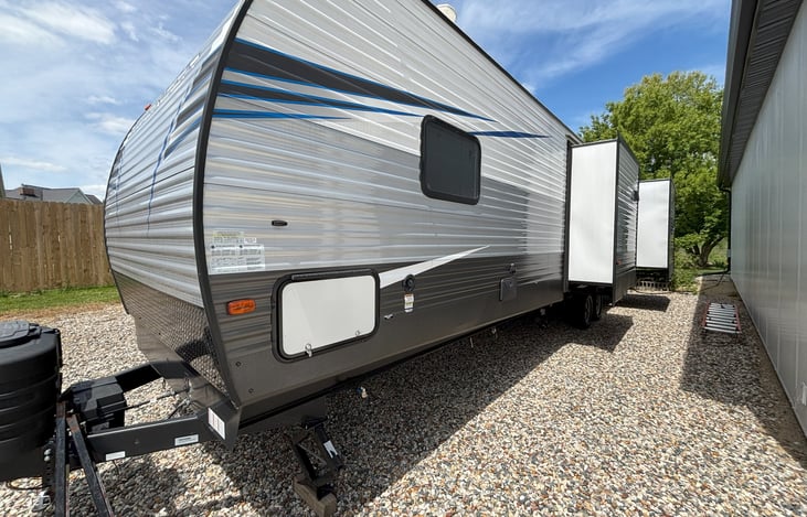 Driver Side Slides (2). Fresh Water Hook up, and Sanitary Hook up on this side.