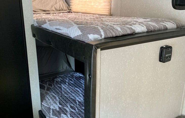 A set of bunks in the rear are perfect for your kiddos to have a little space of their own!