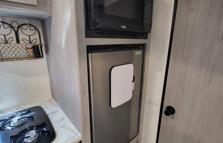 Refrigerator runs off 12v and shore power. Microwave off shore power only.