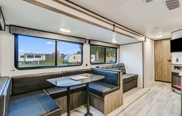 Spacious dining and couch area for hanging out with full entertainment center.