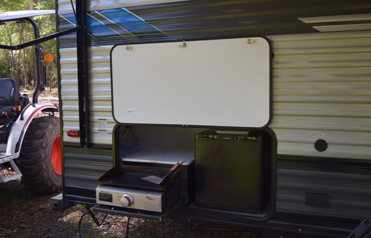 Outdoor grill and fridge.