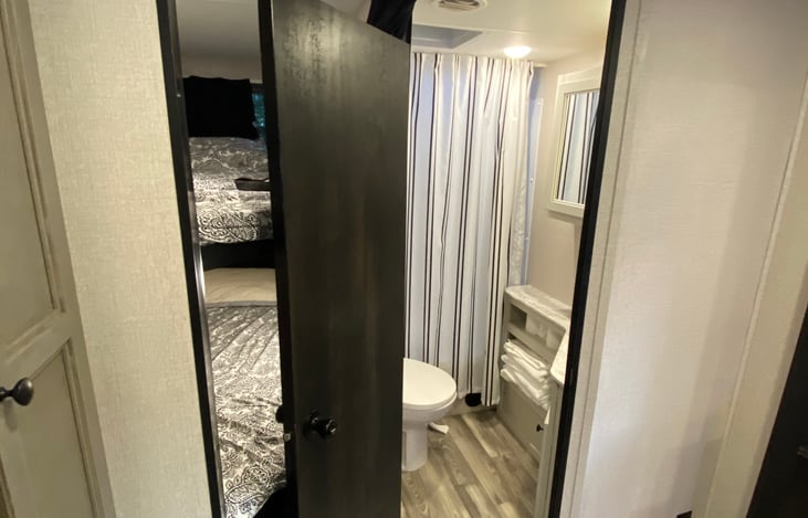 Entrance to restroom and bunks to left