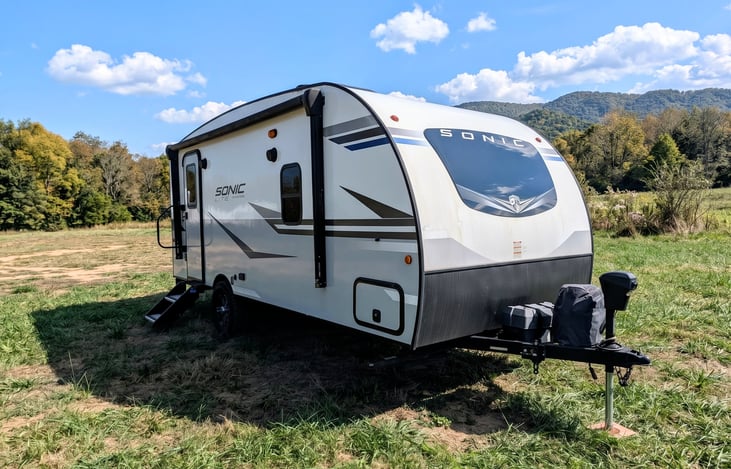 Easy-tow 2022 Venture Sonic Lite (3,600 lbs)! Features off-grid solar, all-terrain tires, slide-out, spacious rear kitchen, queen bed & power awning. Perfect couple's getaway for any adventure!